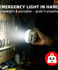 Hand holding Beefy 3000LM Rechargeable Camping Light With Magnetic Hanging Hook, 4000mAh Battery, in workshop setting.