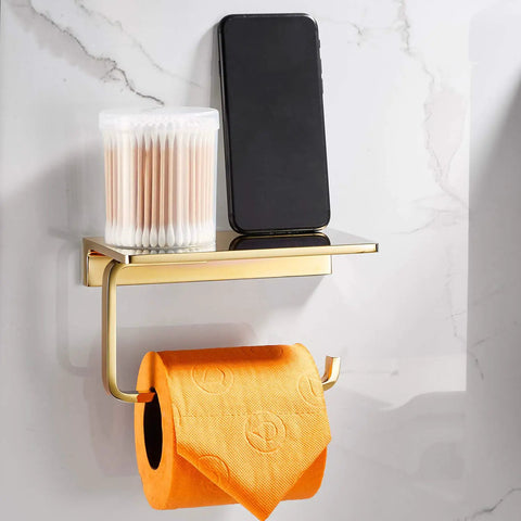 Solid Brass Toilet Paper Holder With Gold Finish, Hotel Style Tissue Roll Holder Plus Built In Cell Phone Shelf, Rust Resistant Chrome Finish, Pro Grade Heavy Duty Bathroom Organizer For Rolls Up To 5.31 Inches, shown holding orange toilet paper.