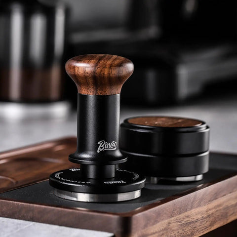 58mm Espresso Tamper With Ripple Base And Spring Loaded Precision Pressure For Even Extraction, shown with walnut handle on tray