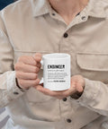 Person holding Engineer Definition Funny Gift Mug For Engineering Students Teachers And Pros Nerdy Computer Civil Mechanical Electrical Software Engineers 11 Oz White Ceramic Coffee Mug