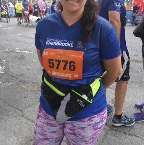 Runner wearing Upgraded No Bounce Hydration Belt With Cut-To-Size Strap For Men And Women, Black, at a marathon event.