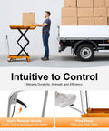 Front view of orange hydraulic lift table cart with scissor lift lifting a cardboard box beside a loading truck.