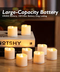12 Pack Timer Flameless LED Votive Candles For Weddings With Auto On Off 6H 18H glowing on wooden table with books