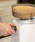 Hand adjusting Beefy 1200W High Speed Electric Grain Mill For Fresh Flour with grains in hopper