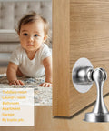 Heavy Duty Silver Stainless Steel Door Stopper With Magnetic Catch Holds Doors Open Durable Security Door Stopper For All Surfaces Rust Resistant And Long Lasting 1 Pack installed on wooden door in room with child in background.