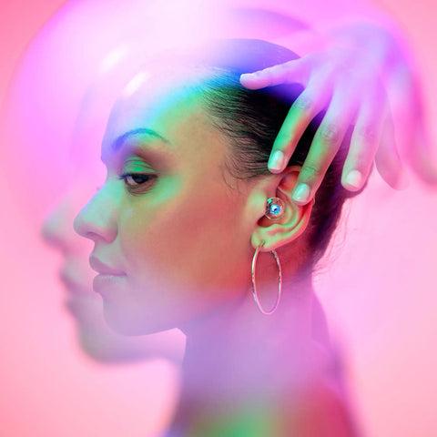 Woman wearing Customizable Gemstone Earplugs With 21 dB Noise Reduction For Clear Hearing At Concerts, Raves, and Events