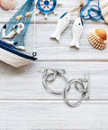 Rock Solid Stainless Steel Pad Eye Plates And Heavy Duty Mounting Rings With M5 Threads for marine rigging, shown on light wooden background.