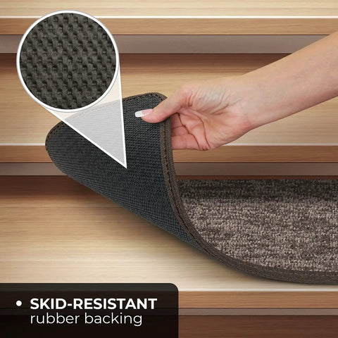 Hand lifting skid-resistant carpet stair tread to show non-slip rubber backing for safer stairs, pebble gray, 8x27 inches.