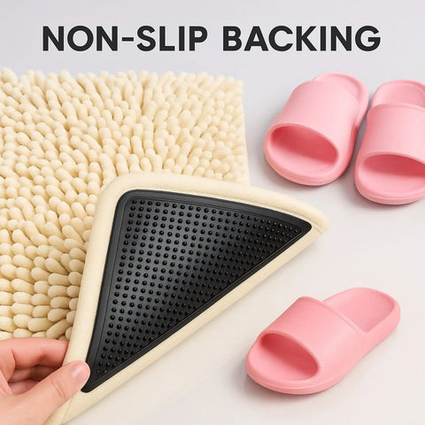 Heavy Duty Rug Gripper Pads With Adhesive Strips For Non Slip Carpet Corners Kit shown beneath a textured rug with pink slippers.