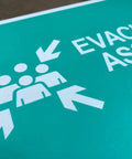 No Nonsense Heavy Duty Reflective Emergency Assembly Point Sign with evacuation graphic and directional arrows.
