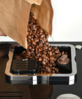 Top Notch Automatic Espresso And Coffee Machine With Built In Grinder pouring fresh coffee beans into hopper.