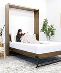 Kickass DIY Murphy Bed Kit Equipped With Heavy Duty Spring Lift Hardware Built From Commercial Grade Steel For Queen Full Or Twin Bedroom Storage Solutions in modern room with woman reading.