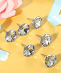 Crystal Upholstery Nails Tacks Set, 150 Piece Diamond Crystal Fasteners displayed on yellow surface with pink and blue accents.