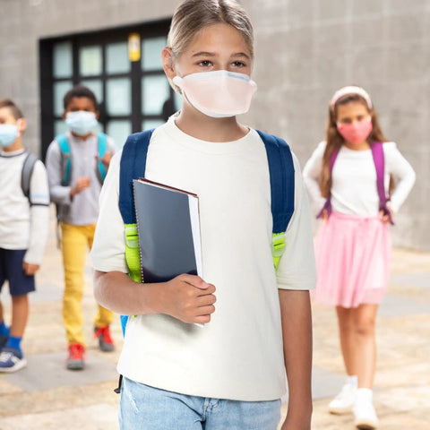 Child wearing FluidShield N95 Respirator Mask With ASTM Level 3 Protection Small Orange Face Cover in schoolyard