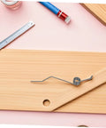Upgrade Your Baskets With Heavy Duty Trash Can Lid Torsion Springs That Hold Tight And Stay Quiet For Easy Home Maintenance DIY Repair Parts, black metal spring on wood board