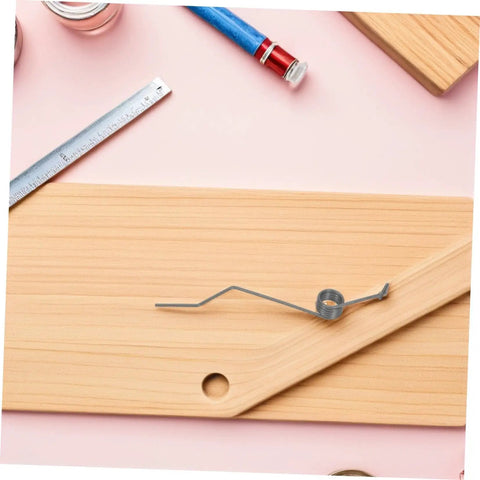Upgrade Your Baskets With Heavy Duty Trash Can Lid Torsion Springs That Hold Tight And Stay Quiet For Easy Home Maintenance DIY Repair Parts, black metal spring on wood board