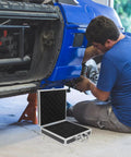 Premium Aluminum Tool Box Featuring Heavy Duty Build And Secure Snap Lock Cover For Van Life Adventures Job Site Projects Weekend Warrior Gear Compact Alloy Storage Case open next to a mechanic working on a car.