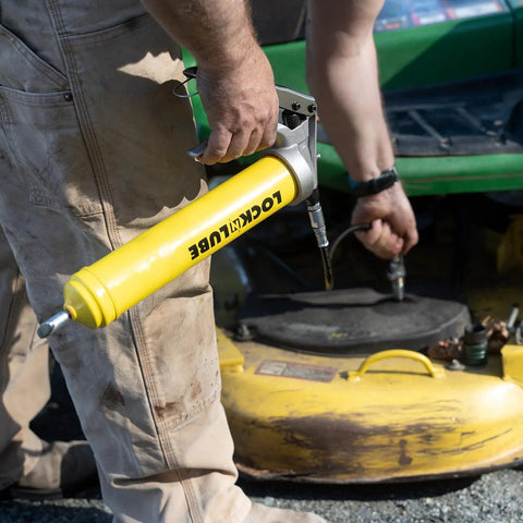 LockNLube premium pistol-grip grease gun with yellow body, locking coupler, and 20-inch hose.