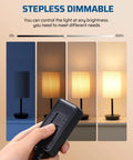 Hand adjusting Plug In Lamp Dimmer Switch With Full Range Dimming And Smooth Slider No Fuss Works With Dimmable LED CFL And Incandescent Bulbs 6.6 Ft Extension Cord Black 2 Pack, demonstrating dimming effect on lamp.
