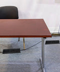Office space with desk, chair, and Long 98.43 Ft Carpet Cord Cover And Cable Protector Floor Strip For Office And Commercial Spaces Black No Fuss Hook And Loop Cable Management Cut To Length Easy Install Keeps Cables Safe From Trip Hazards visible on gray carpet.