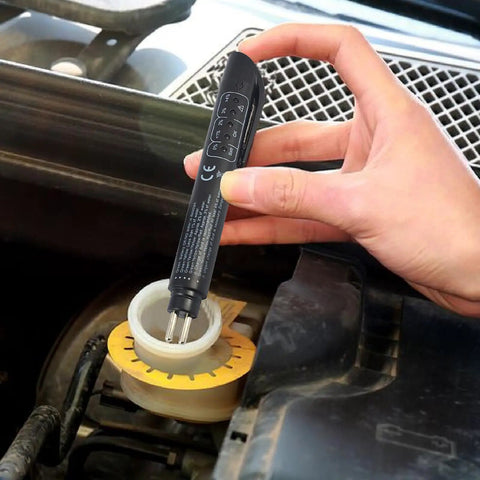 Hand using Pen Style Brake Fluid Tester With Five LED Indicators For Quick DOT 3 DOT 4 DOT 5.1 Fluid Check on car reservoir
