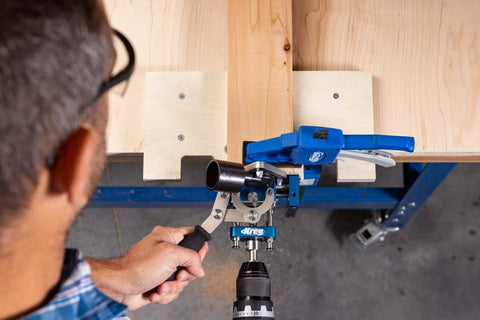 Person using MortiseMate Loose Tenon Jig For Woodworking Easy Mortise Cutter with drill for precise joinery on wooden workbench