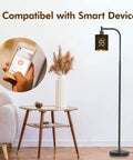 Gothic Style Floor Lamp With Laser Cutout Lampshade LED Arc Standing Light beside modern table with phone control in living room