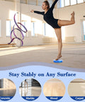 Front view of a dancer on a blue metal turning disc board for pirouette training on a gym floor.