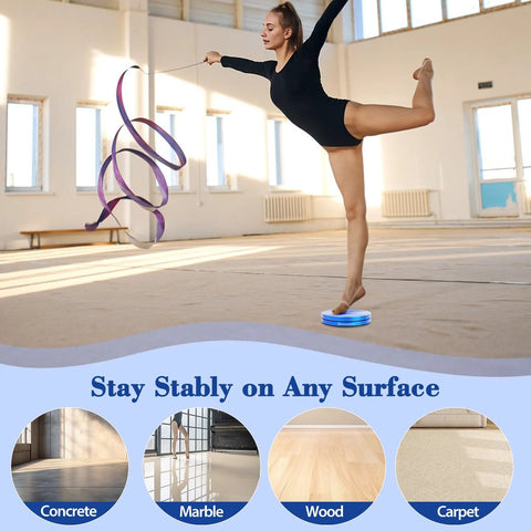 Front view of a dancer on a blue metal turning disc board for pirouette training on a gym floor.