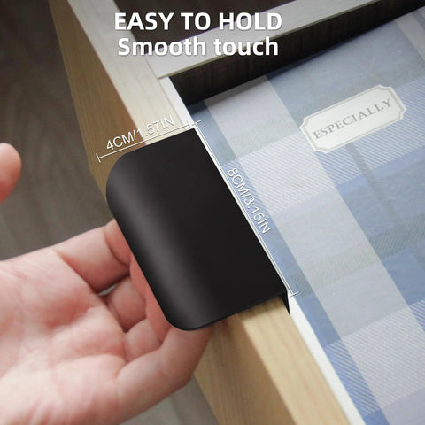 Close-up of black 5 Pack Adhesive Edge Finger Pulls For Cabinets installed on a wooden drawer, featuring no drilling required adhesive design.