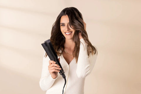Woman holding One And A Half Inch Steam Flat Iron With Dual Voltage Six Heat Settings Up To 450 Fahrenheit Steam Optional, smiling