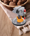Mini Vise Clamp With Suction Mount Fully Rotatable Bench Vise for Woodworking on table with walnuts in basket