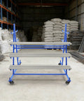 Heavy Duty Five Tier Rolling Storage Rack With Rust Proof Iron Frame And Four Swivel Brake Wheels in a workshop.