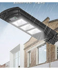 Badass 350W Solar Floodlight With Radar Human Body Induction Dusk To Dawn IP67 Waterproof LED Outdoor Security Light in rain above building.