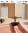 Person adjusting Heavy Duty M8 Adjustable Furniture Leveling Feet with Screw-In Legs under wooden furniture leg, 12 pack