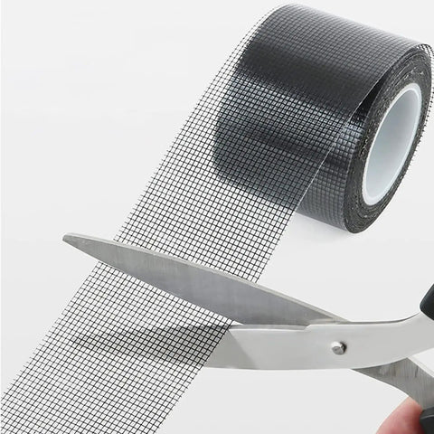 Heavy Duty Window Screen Repair Tape And Mesh Patch Kit 2 Inches By 16 Feet Long Black adhesive strip being cut with scissors.