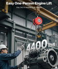 Front view of red VEVOR hand chain hoist (2 ton) with galvanized chain lifting a large industrial motor