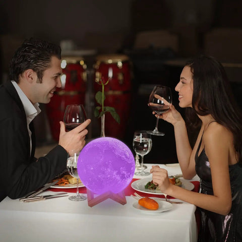 Couple dining with Moon Lamp 7 Inch 3D Printed Moon Light with Stand, 16 Color LED Night Light, Remote Control, Touch Sensor on table