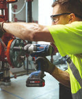 Heavy Duty 18 Volt Cordless Impact Wrench With Half Inch Drive Friction Ring And Beast Mode Torque For Stubborn Bolts Along With Three Speed Settings To Get The Job Done Bare Tool Setup being used by a worker on a valve.