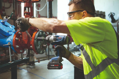 Heavy Duty 18 Volt Cordless Impact Wrench With Half Inch Drive Friction Ring And Beast Mode Torque For Stubborn Bolts Along With Three Speed Settings To Get The Job Done Bare Tool Setup being used by a worker on a valve.