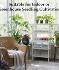 Five Tier Seed Starter Tray Stand With Self Watering Reservoir For Indoor And Outdoor Seedlings And Greenhouse Use A Space Saving Shelf For Small Cell Trays And Nursery Pots White with plants in a sunlit room.
