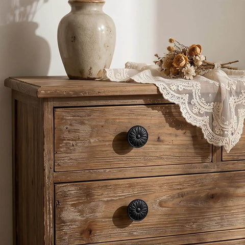 Ten Pack Matte Black Kitchen Cabinet Knobs One And A Quarter Inch Diameter Zinc Alloy Drawer Pulls installed on wooden dresser