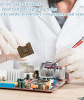 Technician working on a circuit board with components, highlighting electronic soldering capabilities.