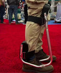Side view of strap-on knee seat for gardening with durable iron frame, supporting up to 330 pounds, on red carpet background