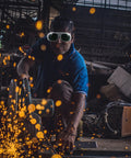 A worker using Badass Welding Glasses With Anti Glare Black And Gray Lenses during metal fabrication, protecting eyes from sparks.