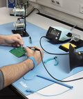 Person using ESD Soldering Mat Blue 600mm By 900mm Pro Grade Large Work Surface with soldering tools and equipment