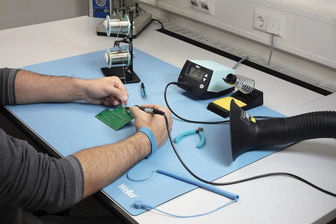 Person using ESD Soldering Mat Blue 600mm By 900mm Pro Grade Large Work Surface with soldering tools and equipment