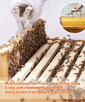 Beekeeping Frame Gripper and Frame Lifter Tool Stainless Steel Frame Holder With Wood Handle lifting a bee-covered frame.