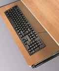 Top Tier Heavy Duty 14 Inch Under Desk Keyboard Tray Rails With Dead Smooth Ball Bearing Slide And Fully Adjustable Height For A Real Deal Ergonomic Office Setup Black, showing keyboard on wood desk.