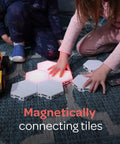 Children playing with 7 Piece Tap Tap Sensory Lights Kit With Touch And Remote Control Multicolor Magnetic Hexagon Tiles on floor.